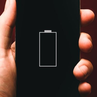 Person holding low battery smartphone - Photo by Alexander Andrews on Unsplash